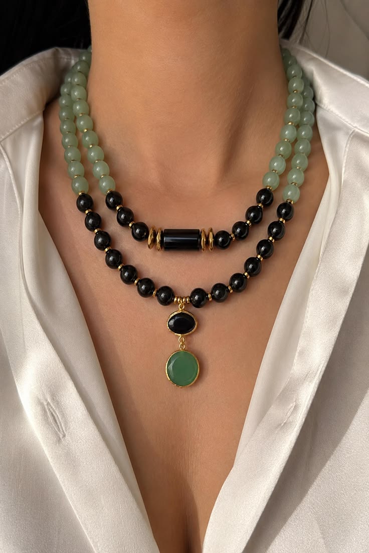 oréva Cowrie Collar statement necklace on dark background