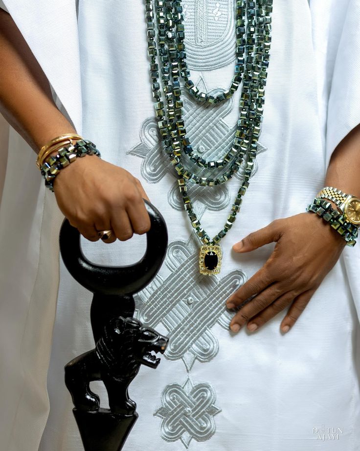 oréva bridal collection, groom wearing beaded bracelets and neck pieces